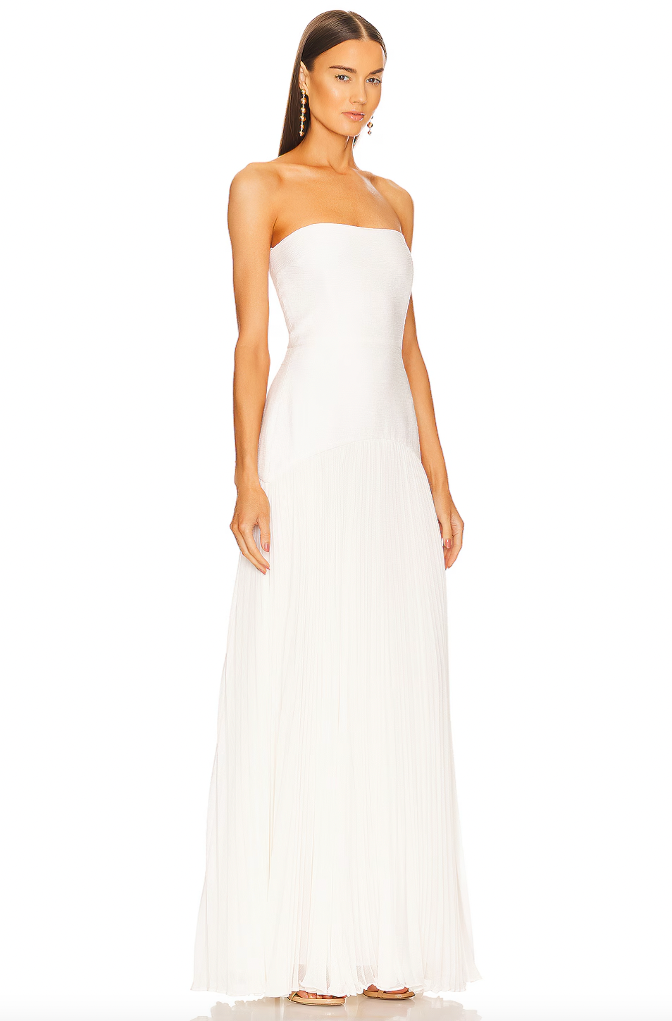 The Sunniva dress by Alexis is a timeless and sophisticated piece, perfect for any elegant occasion. Its strapless fit to flare design highlights your waist and flows into a pleated maxi skirt. Make a statement at any wedding, gala, or event with this stunning gown. Complete the look with drop earrings and a chic clutch.