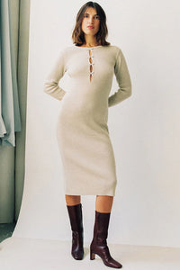 Experience effortless chic this autumn and winter with our Ines Midi Dress. Made from high-quality rib knit fabric, this vintage cutout dress features a figure-hugging silhouette, cascading cut-outs with bows, and a crew neckline. Perfect for work from home or dressing up on off-duty days. Complete the look with mid-calf heeled boots and a snakeskin baguette bag.