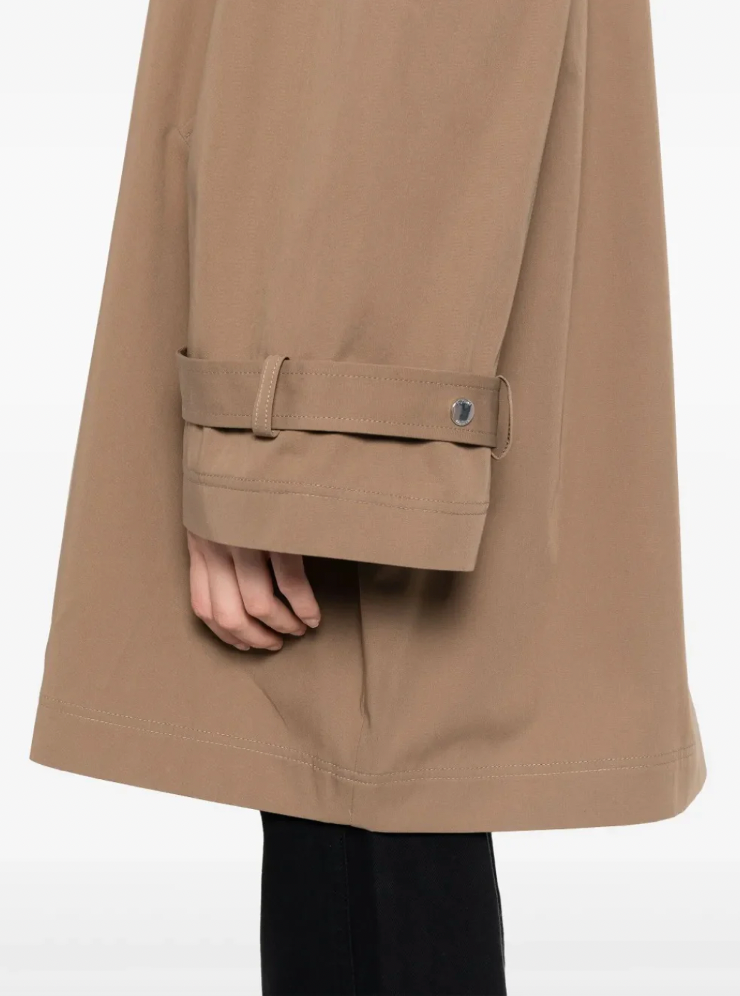 Elevate your everyday style with this hazel brown oversized trench jacket by Toteme — a timeless piece that effortlessly transitions from office to weekend. The classic collar and concealed front zip create a sleek silhouette, while belted cuffs add refined detail and adjustability. Practical side welt pockets keep essentials within reach without disrupting the polished line. Perfect for layering or wearing solo, this relaxed-fit jacket delivers sophisticated versatility that works season after season.