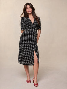 Feel effortlessly chic and sophisticated in our Carmen Midi Dress. The black and white weight print adds a touch of elegance while the V neckline and five button and tie fastening on the front create a flattering silhouette. The lined skirt ensures comfort and poise. Perfect for any occasion.