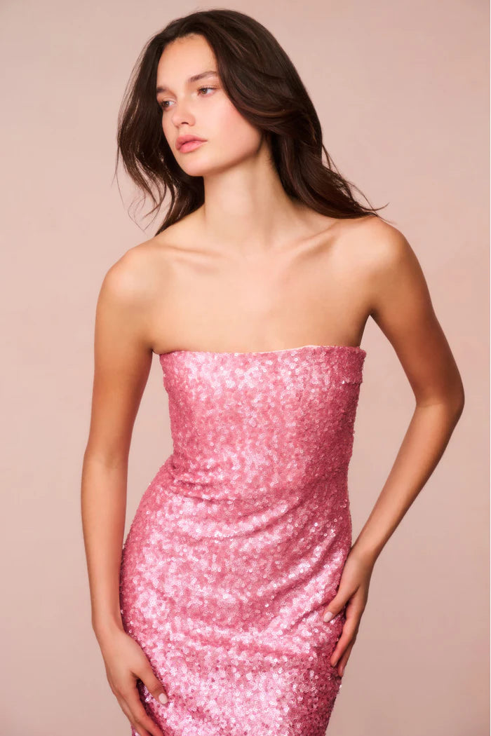 Introducing the Stasia Midi Dress, the star of your next party. Made from a luxurious sequin sheathing fabric, this dress features a stunning ombre pattern in shades of light pink to deep fuchsia. Shimmer and shine all night long with added glitter details. Elevate your event or holiday look with LoveShackFancy's signature sparkle.