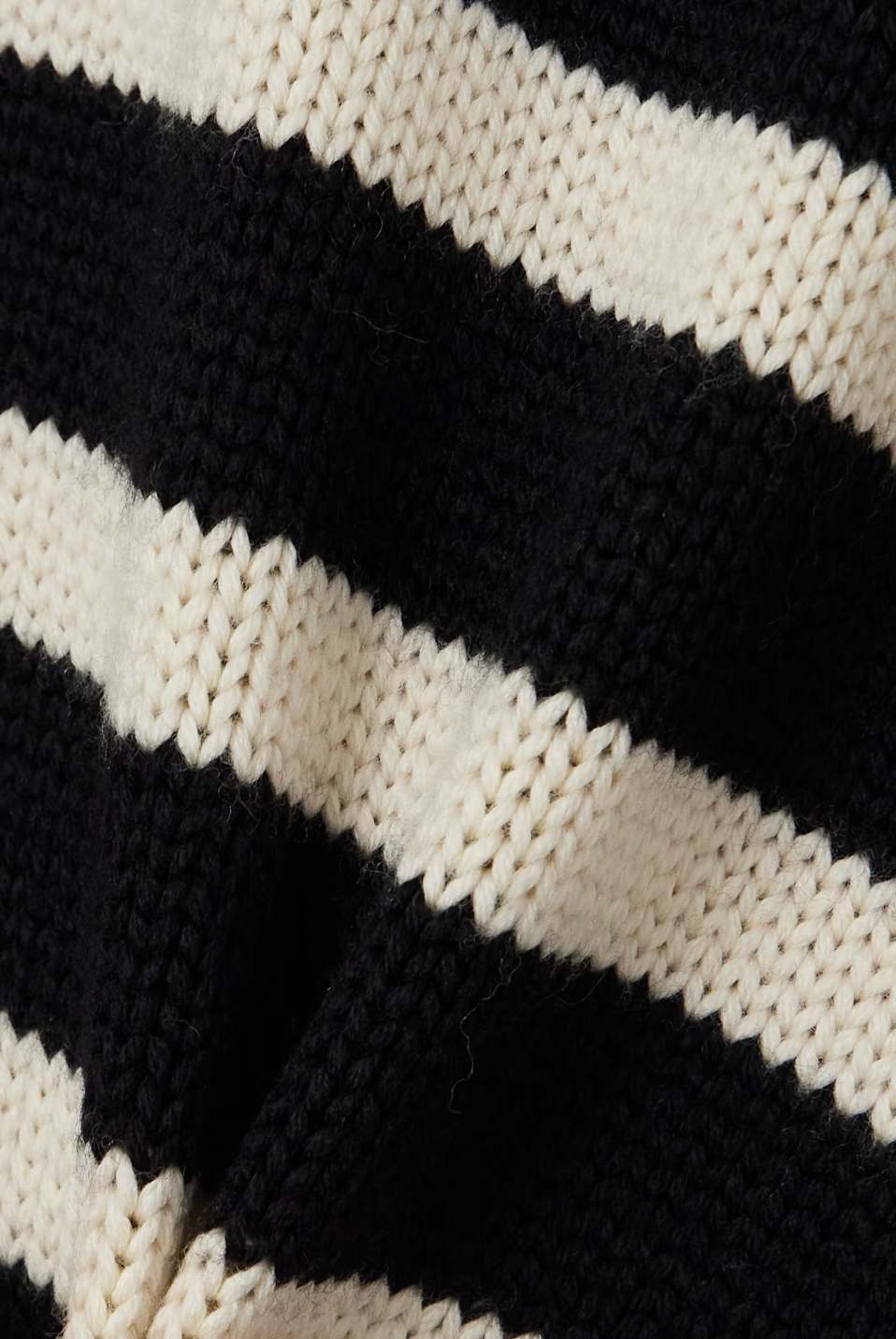 This striped wool-blend turtleneck sweater from TOTEME combines timeless style with cozy comfort. Crafted from a soft blend of wool and organic cotton, it features a relaxed fit and a classic turtleneck, making it perfect for layering. The iconic stripes add a refined touch, while the breathable fabric ensures warmth without bulk. Pair it with tailored pants for an effortlessly polished look that lasts season after season.