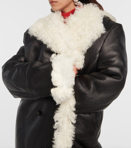 Indulge in luxury with the Magda Butrym Shearling-lined leather coat. Made with premium quality leather and lined with soft shearling, this coat offers both style and comfort. Perfect for chilly winter days, it is a must-have addition to your wardrobe. Elevate your fashion game with this sophisticated and exclusive piece.