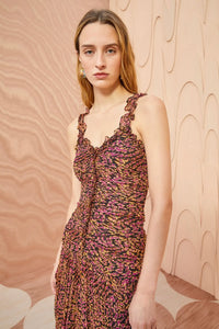 Expertly crafted from lightweight silk crinkled chiffon, the Rosaria Dress boasts a playful micro-painted leopard print in shades of pink and brown. This sleeveless midi dress features delicate ruffle trims, a flattering silhouette, and a hidden back zipper for easy dressing. Fully lined for added comfort.