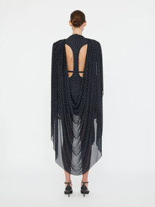 Embrace a nostalgic 90s vibe with the Torrent Draped Mini Dress by Christopher Esber, featuring a striking blue on black warped polka dot pattern inspired by a summer rain shower. The mini silhouette, enriched with gathered and cinched drapes, creates dynamic movement and captivating dimension. Its asymmetric draped skirt and fully lined construction offer effortless style and comfort, making it the perfect choice for standing out with subtle, artistic flair. 