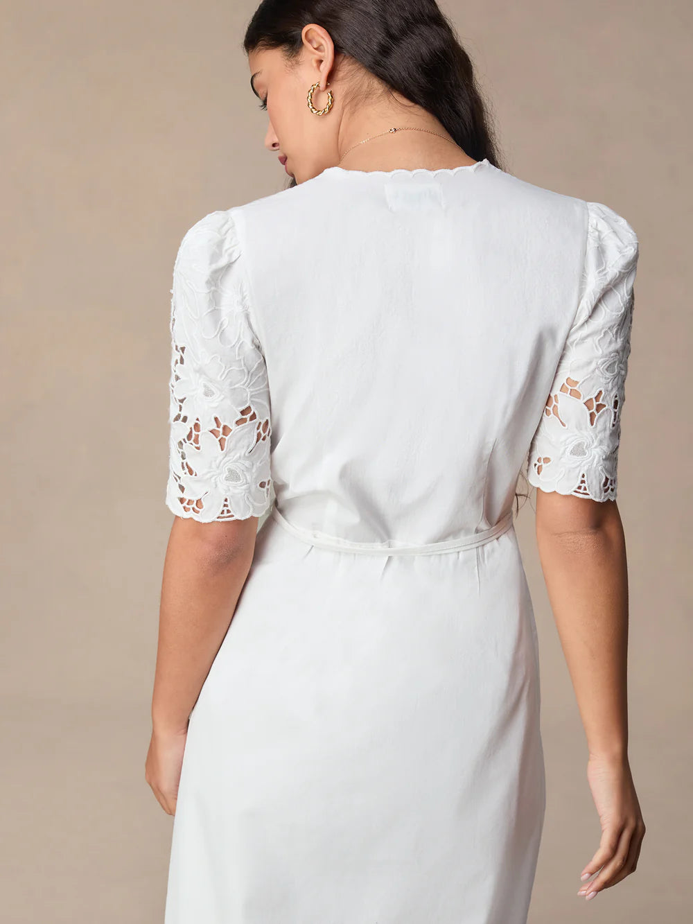 Transform your wardrobe with our Sara Midi Dress! This stunning white embroidered wrap dress exudes elegance and charm. Perfect for any occasion, its mid-length style offers a timeless silhouette that will flatter any body type. Make a statement with this must-have dress that will leave you feeling confident and beautiful.