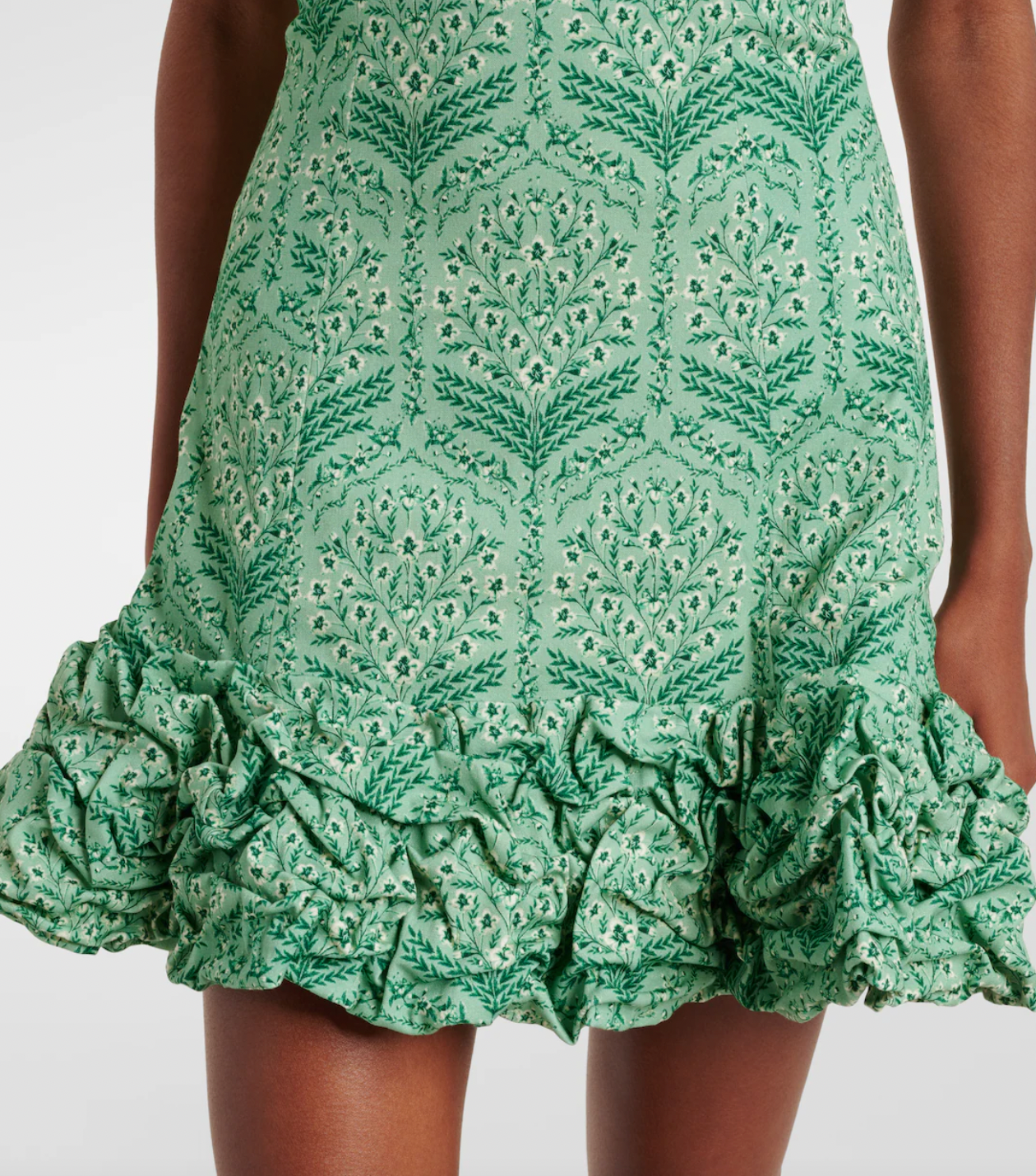 Discover the artistry of Agua by Agua Bendita's Jardín minidress, a stunning piece handcrafted by talented female artisans in Medellín, Colombia. This charming design features a soft cotton-blend poplin fabric with a playful ruffled hem and elegant off-shoulder neckline that flatters every silhouette. Each dress tells a story of skilled craftsmanship and celebrates the vibrant spirit of Colombian artistry. 