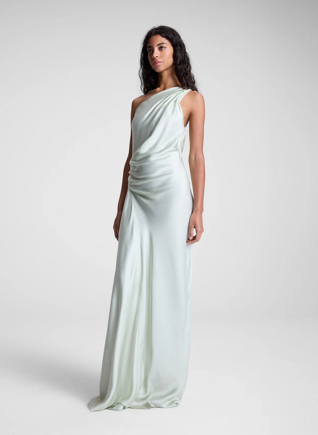 The Aster Satin One Shoulder Gown by A.L.C in radiant chartreuse offers a stunning blend of elegance and modern design. Crafted from smooth satin, it features a graceful one-shoulder cut that flows beautifully over the body. Soft pleats at the shoulder and waist sculpt the silhouette, while the asymmetrical design enhances movement and visual interest. Perfect for making a memorable statement, this gown effortlessly combines sophistication with bold charm.