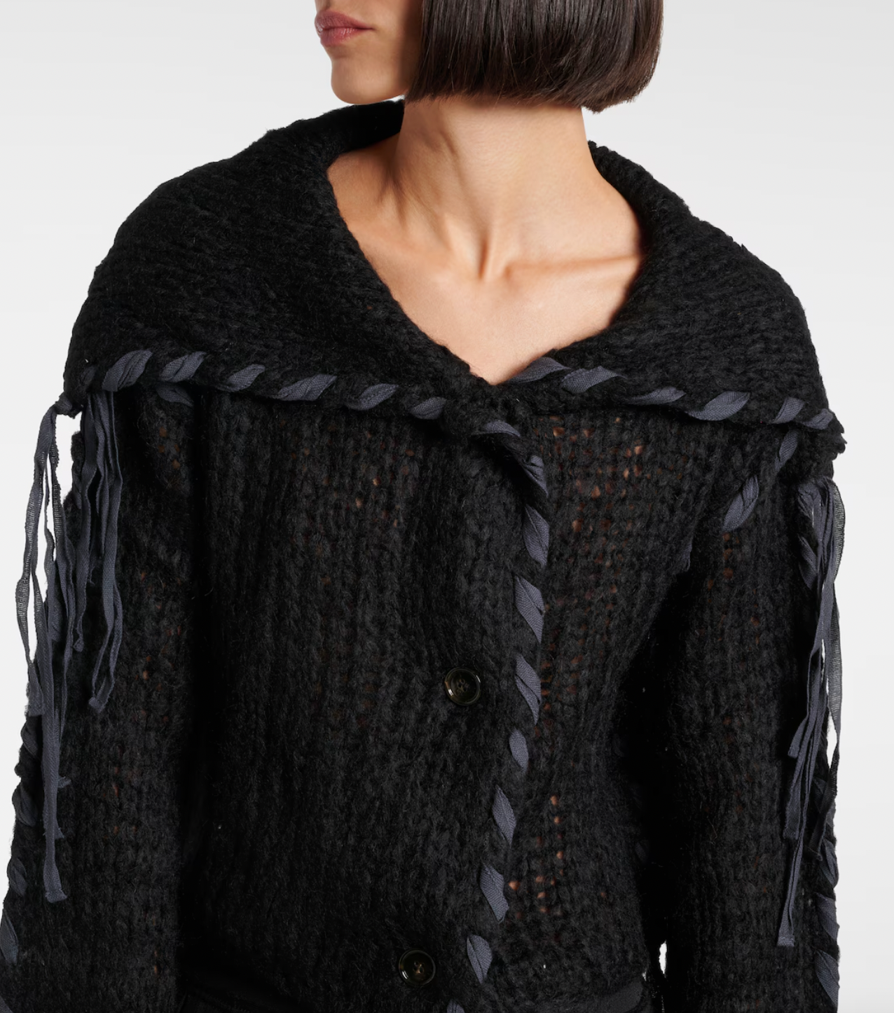 Experience refinement and warmth with the Black Lacing Knit Cardigan by Acne Studios. This exquisite piece features a hand-knitted blend of wool and mohair, complemented by intricate lace-up detailing on the body and sleeves. The elongated collar adds a touch of sophistication, while the waist length provides a flattering fit. Perfect for those seeking luxury and style in their wardrobe.