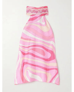 This top from Pucci showcases the brand’s signature Marmo motif rendered in bold, psychedelic prints with vibrant palettes. Crafted from luxurious silk, it offers a smooth, lustrous finish that enhances the rich colors. The elegant halter neckline adds a refined silhouette, making it a standout piece that combines artistic design with sophisticated wearability.