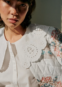 The Flavie Shirt by Sezane combines timeless elegance with a standout design featuring a large embroidered collar that adds a touch of sophistication to your look. Its long sleeves and buttoned front offer both comfort and versatility, making it perfect for dressing up or down. Elevate your wardrobe with this statement piece that effortlessly blends classic style and unique detail.