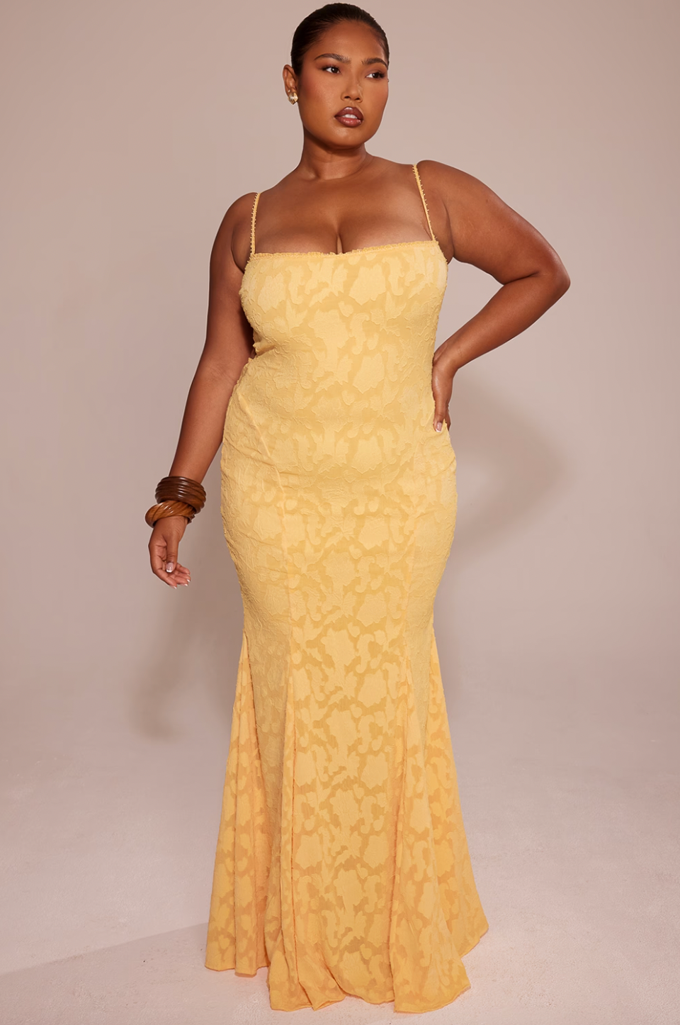 Cut from delicate burnout lace, the Joan Lace Dress elegantly celebrates femininity with refined craftsmanship. Its dainty trimmed neckline and straps lead to an open back fastened with satin ties, allowing a personalized fit. The dress gracefully skims the figure, extending into a floor-length maxi silhouette that flares into a sophisticated godet skirt, adding movement and timeless glamour to this exquisite piece.