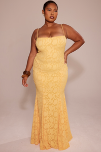 Cut from delicate burnout lace, the Joan Lace Dress elegantly celebrates femininity with refined craftsmanship. Its dainty trimmed neckline and straps lead to an open back fastened with satin ties, allowing a personalized fit. The dress gracefully skims the figure, extending into a floor-length maxi silhouette that flares into a sophisticated godet skirt, adding movement and timeless glamour to this exquisite piece.
