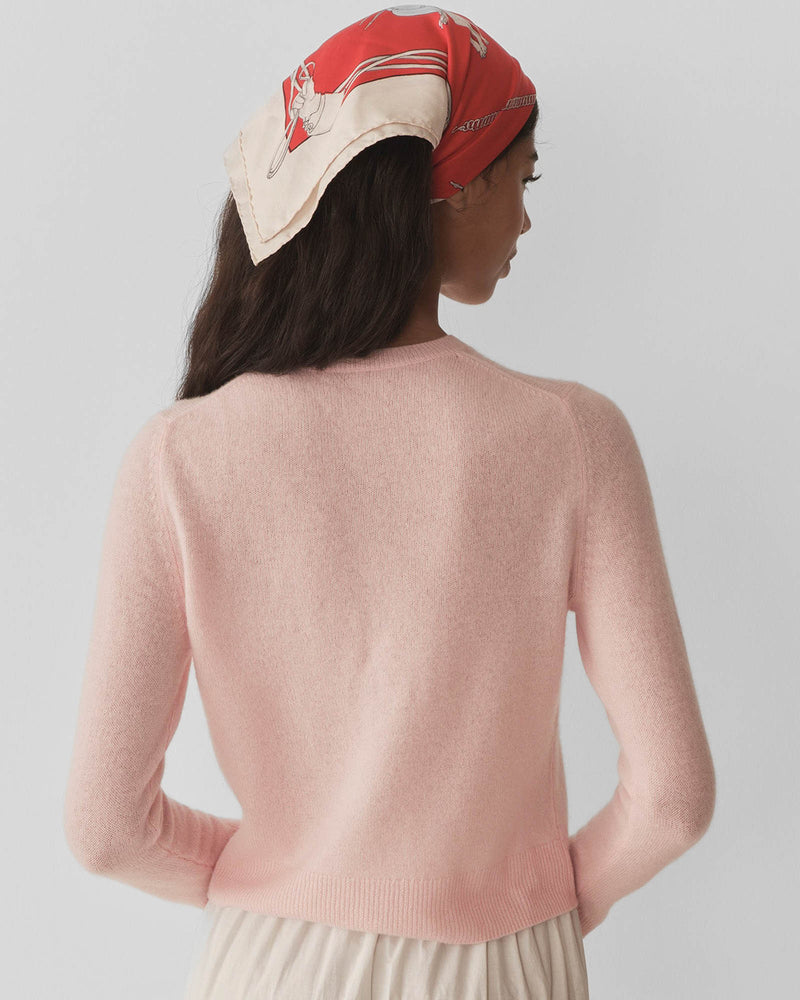 Embrace timeless elegance with the Freya Cardigan by Doen, a luxurious piece that channels 1960s sophistication. Crafted from sumptuous 100% cashmere, this fitted cardigan features a classic crew neck and bracelet-length sleeves that flatter every frame. Mother-of-pearl buttons add an understated touch of refinement, while the tailored silhouette ensures effortless polish for any occasion. 