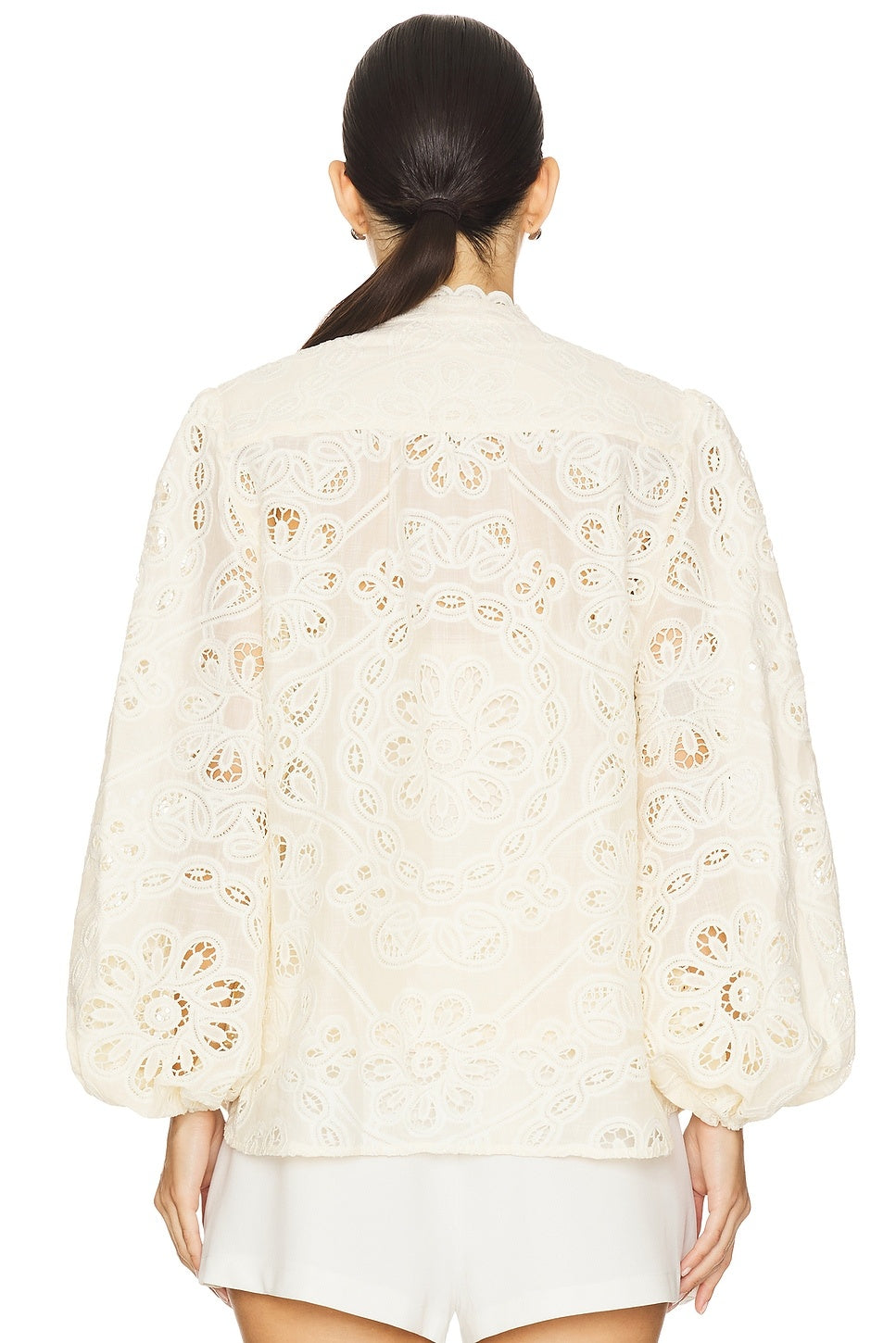 Elevate your everyday style with the Rhiannon Embroidered Blouse by Zimmermann, a charming piece that combines timeless elegance with modern flair. Featuring delicate floral embroidery that adorns the entire design, this blouse makes a sophisticated statement. The romantic puff sleeves with elastic cuffs create a flattering silhouette while maintaining comfort throughout the day. A convenient front button closure allows for effortless dressing and styling versatility. 