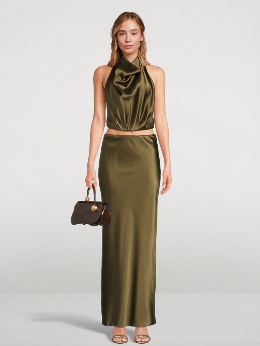 Experience effortless elegance with the Chantel Satin Slip Skirt by Cult Gaia. Cut on the bias for a flattering fit, this maxi-length piece is crafted from glossy silk that gently stretches for comfort. Its smooth, flowing silhouette enhances every movement, making it perfect for both day and evening wear. Elevate your wardrobe with this timeless, luxurious skirt that exudes sophistication and versatility.