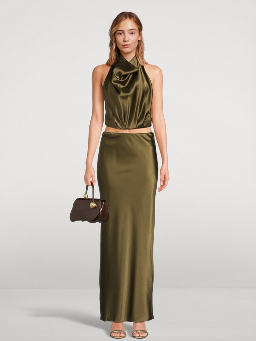 Experience effortless elegance with the Chantel Satin Slip Skirt by Cult Gaia. Cut on the bias for a flattering fit, this maxi-length piece is crafted from glossy silk that gently stretches for comfort. Its smooth, flowing silhouette enhances every movement, making it perfect for both day and evening wear. Elevate your wardrobe with this timeless, luxurious skirt that exudes sophistication and versatility.