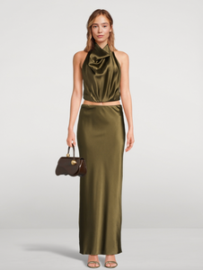 Experience effortless elegance with the Chantel Satin Slip Skirt by Cult Gaia. Cut on the bias for a flattering fit, this maxi-length piece is crafted from glossy silk that gently stretches for comfort. Its smooth, flowing silhouette enhances every movement, making it perfect for both day and evening wear. Elevate your wardrobe with this timeless, luxurious skirt that exudes sophistication and versatility.