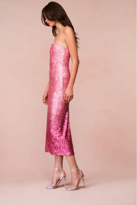 Introducing the Stasia Midi Dress, the star of your next party. Made from a luxurious sequin sheathing fabric, this dress features a stunning ombre pattern in shades of light pink to deep fuchsia. Shimmer and shine all night long with added glitter details. Elevate your event or holiday look with LoveShackFancy's signature sparkle.