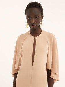 Add an elegant touch to your wardrobe with our Chloe Long Cape Dress. Crafted from luxurious fluid crêpe jersey, this dress exudes sophistication and grace. The flowing cape design adds a touch of drama, making it the perfect statement piece for any special occasion. Elevate your style with this exclusive dress.