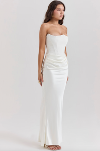 Indulge in luxury with the Ivory Strapless Corset Dress. Perfect for any high-octane occasion, this dress is crafted from stretch crepe and ultra luxe satin. The strapless neckline and boned bodice cinch the waist, while the beautifully draped skirt creates a striking silhouette. Make a statement with its flattering dress.