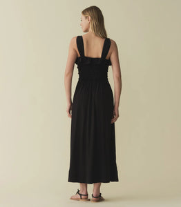 The Carolynn Dress—in a lightweight blend of rayon and viscose—features a square neckline, a gathered bust, and a fitted bodice framed with petite ruffles. Elastic lends give to the bust and waist, giving way to a swingy, ankle-length skirt.