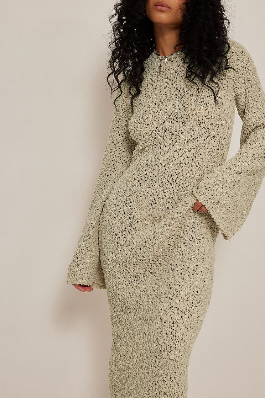 Get ready to turn heads with our Merryl Knitted Dress! This stunning maxi dress features a unique knitted design that will keep you comfortable and stylish all day long. The deep back, tied at the neck, and wide sleeves add a touch of elegance to this dress. Available in beige, it's the perfect addition to your wardrobe for any occasion.