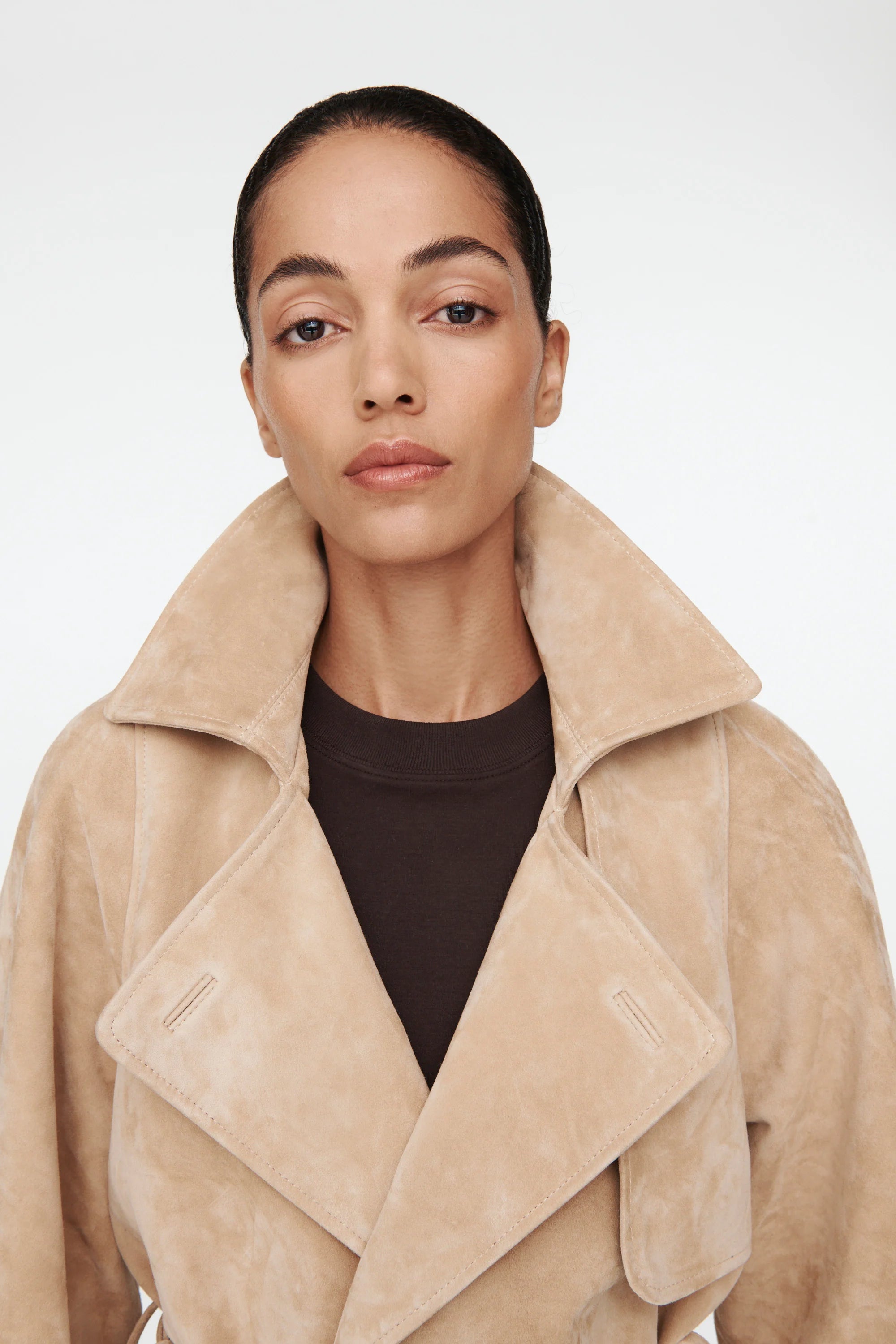 The Millie Suede Jacket by Ducie reimagines the classic trench with modern flair. This cropped silhouette features an oversized collar that commands attention, while adjustable belts at the hem and sleeves offer customizable styling and a polished finish. Effortlessly versatile, it's the ideal layer for elevating your spring and summer wardrobe with contemporary edge and timeless sophistication.