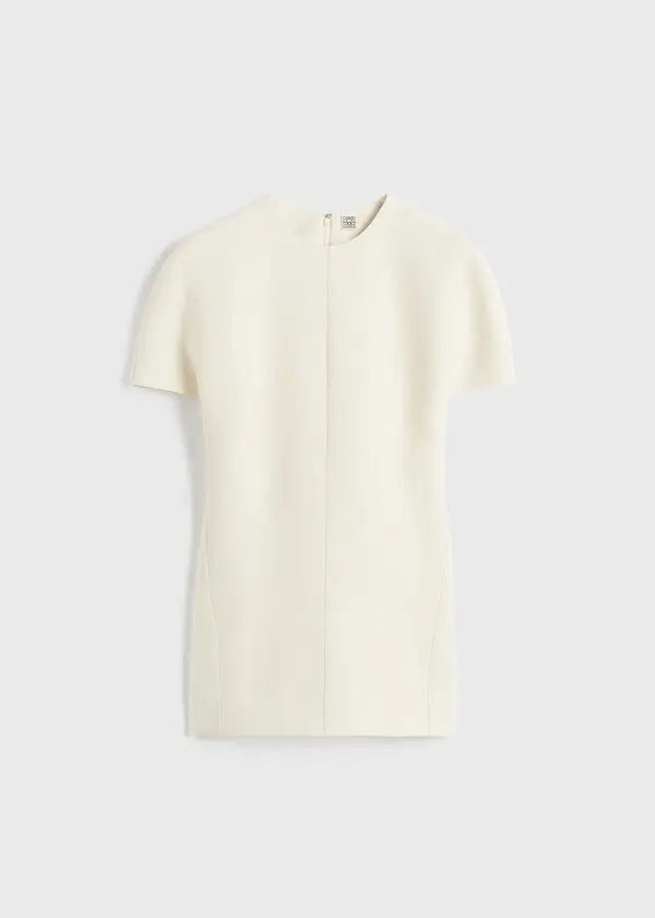 Elevate your wardrobe with this sophisticated TOTEME cap-sleeve top, designed for the modern woman who values refined elegance. The longline silhouette flatters your frame while the distinctive twisted seams add architectural interest to every wear. Crafted from luxurious double-faced cady blended with wool and silk, this piece offers both comfort and durability. The concealed back zipper ensures a seamless, polished look. 