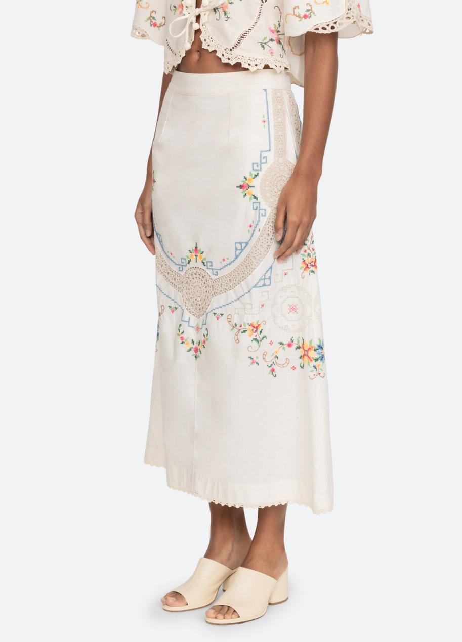 Experience the beauty of handcrafted details with the Edwina Skirt. The cross stitch embroidery and crochet trim add a touch of elegance to any outfit. Perfect for adding texture and a unique touch to your wardrobe. Elevate your style with the Edwina Skirt.