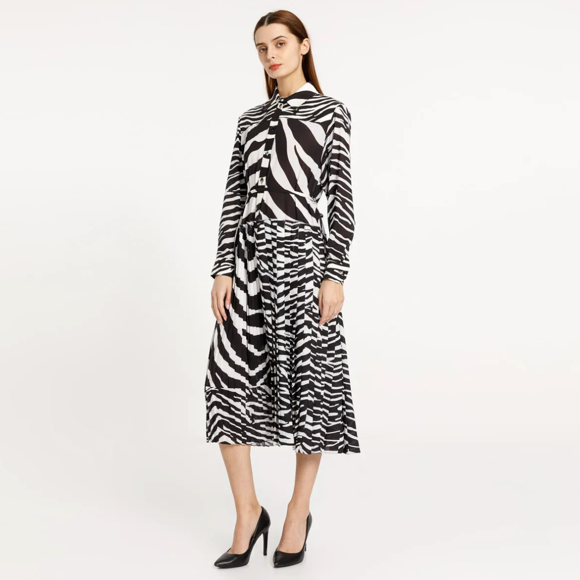 Elevate your style with our Poplin Chemisier Dress. This midi dress features a unique zebra pattern and pleated design, adding a touch of sophistication to your wardrobe. Perfect for any occasion, this dress is sure to make a statement.