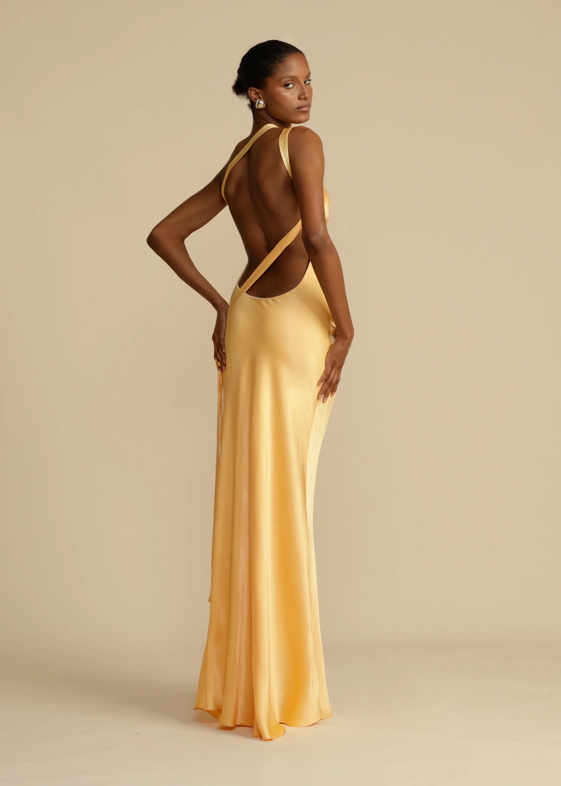 Indulge in luxury with our Micah Maxi Dress! Made from elegant silk, this stunning dress features an inclined shoulder, backless design, and sleeveless cut. Perfect for any occasion, it'll turn heads and make you feel like you're walking on a high street runway. Elevate your wardrobe with this chic and sophisticated Robe.