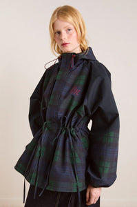 Embrace rainy days with the Liu Coat from Damson Madder, featuring a classic Black Watch tartan design crafted from shower-resistant fabric. Its balloon-style cuffs, adjustable hood, and cinchable waist offer both comfort and a flattering silhouette, while signature 'DM' embroidery adds a touch of distinction. Equipped with practical pockets and thoughtful details, this coat effortlessly combines style and functionality, making it the perfect shield against wet weather.