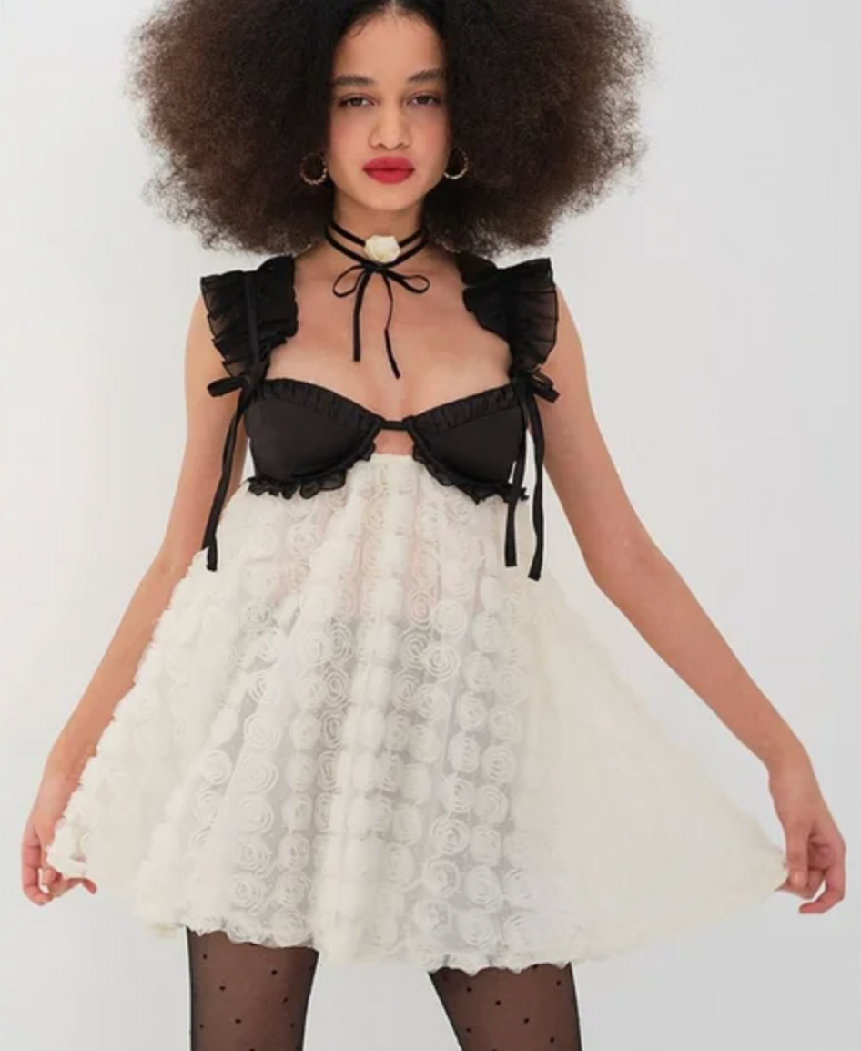 Introducing the Poppy Mini Dress by For Love & Lemons, made with luxurious 3D rose flock dot fabric. Feel pampered with contrast satin cups and supportive underwire. Delicate chiffon ruffled straps add a touch of elegance, while the sheer skirt and keyhole back make a striking statement. With a convenient S-hook and invisible zip closure, this fully lined dress is the epitome of sophistication.