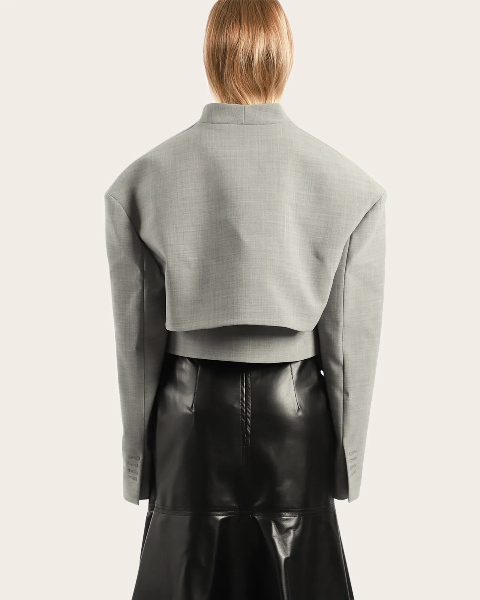 Elevate your wardrobe with this statement cropped jacket by Awake Mode that seamlessly blends bold design with everyday wearability. Featuring dramatic dropped shoulders, voluminous wide sleeves, and an attached insert vest, this piece commands attention while remaining surprisingly versatile. Strategic cutout details at the front create an asymmetrical silhouette that flatters and intrigues, while practical side pockets keep you functional. 