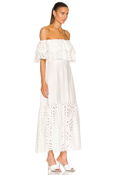 Get ready to show off your fun and flirty side with the Isabella Maxi Dress from Charo Ruiz! Made from a delicate broderie anglaise cotton-blend, this off-the-shoulder dress features tiered layers for added movement and style. Perfect for any occasion, this midi dress will have you feeling confident and fabulous.