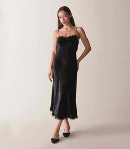 Rendered in sumptuous velvet, the Calsi Dress is a take on a ‘30s-style slip dress. It features ultra-skinny silk satin straps, bust darts for structure, and shirring at the bust for a subtle sweetheart neckline. A fitted waist gives way to an A-line skirt that falls to mid-calf, while petite silk organza ruffles adorn the neckline and hem.