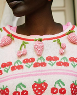 Load image into Gallery viewer, The Renton Pullover is a charming blend of cotton and wool, adorned with a delightful strawberry and cherry motif. Hand-crocheted strawberries add a touch of whimsy. With a shrunken fit and ribbed neckline, cuffs, and border, this sweater is both cozy and stylish. Adorned with strawberry buttons down the back, it&#39;s the perfect addition to any wardrobe.
