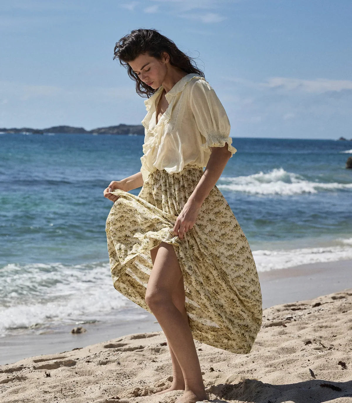 Elevate your wardrobe with the Marcie Skirt in Citron Rosier Floral by Doen, designed for timeless elegance and comfort. Crafted from a soft organic cotton and viscose blend, this high-waisted skirt features a flowing ankle-length silhouette adorned with a vintage-inspired poppy field print. Pintuck details and an invisible side zipper provide a flattering fit, making it a versatile choice for both casual days and special occasions. Experience effortless style with every wear.