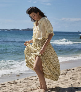 Elevate your wardrobe with the Marcie Skirt in Citron Rosier Floral by Doen, designed for timeless elegance and comfort. Crafted from a soft organic cotton and viscose blend, this high-waisted skirt features a flowing ankle-length silhouette adorned with a vintage-inspired poppy field print. Pintuck details and an invisible side zipper provide a flattering fit, making it a versatile choice for both casual days and special occasions. Experience effortless style with every wear.