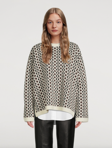 Indulge in the luxurious warmth and style of the Knit Cross-Pattern Wool Pullover by TOTEME. Crafted from high-quality virgin wool, this Norwegian-inspired piece boasts a structured fit and wide silhouette for a sophisticated look. The jacquard woven fabric features a unique cross pattern, while the ribbed neck, cuffs, and hem add texture and comfort. With dropped shoulders and side slits, this pullover is both elegant and versatile. 