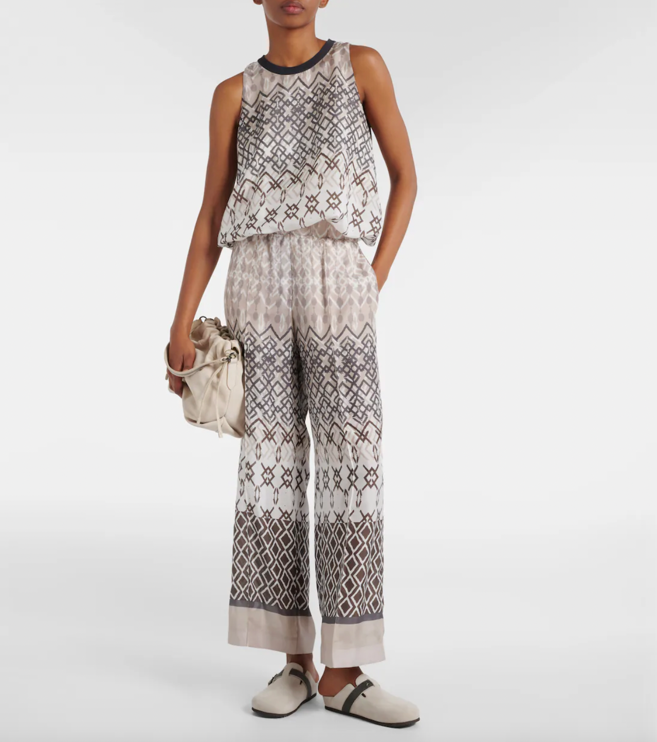 Introducing Brunello Cucinelli's wide-leg pants, made from luxurious pure silk-voile for maximum comfort. Featuring an elasticated waist and a stylish geometric print in versatile neutral tones, these pants are perfect for your vacation wardrobe. Enjoy a comfortable and chic look all vacation long.