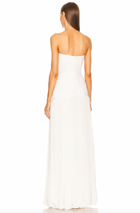 The Sunniva dress by Alexis is a timeless and sophisticated piece, perfect for any elegant occasion. Its strapless fit to flare design highlights your waist and flows into a pleated maxi skirt. Make a statement at any wedding, gala, or event with this stunning gown. Complete the look with drop earrings and a chic clutch.