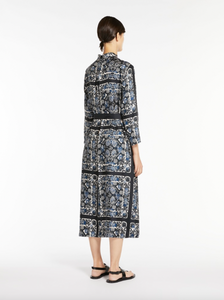 Elevate your style with the Max Mara Printed Silk Dress. The caftan-style dress is crafted from exquisite, printed silk that gives it a beautiful flow. With its slightly flared silhouette, mandarin collar, and matching belt, this dress accentuates your waist for a flattering look. Finished with hidden mother-of-pearl buttons and a back pleat for added elegance.