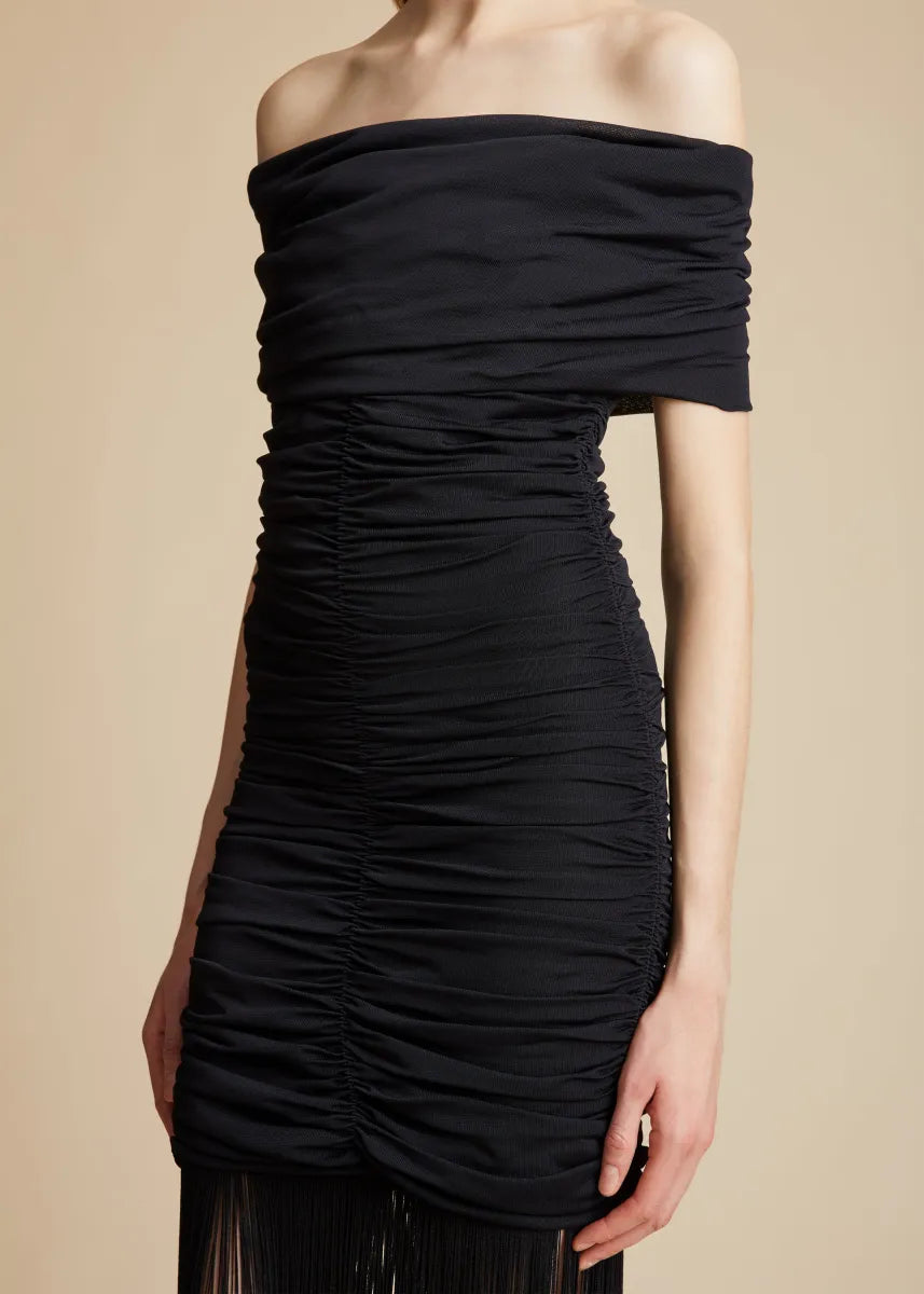 Introducing the Jacinta Dress in Black by Khaite, the epitome of elegance and contemporary flair. From the Pre-Fall collection, this off-the-shoulder knit dress is crafted from fine crepe viscose for a sleek silhouette. The enticing draping and rich texture, along with playful fringe detailing, make this piece perfect for any evening event or chic gathering. With no closures, it offers effortless wear and a close fit, elevating any occasion.