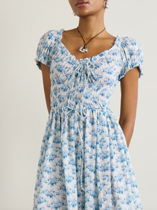 Experience effortless romance with the Ashlynn midi dress by DÔEN. Crafted from breathable organic cotton-voile, its all-over floral print captures a timeless, delicate charm. The shirred bodice offers a comfortable fit, while adjustable ties at the neckline and waist allow you to tailor the silhouette to your liking. Perfect for warm days and graceful evenings, this dress brings Southern Californian ease to your wardrobe with eco-friendly elegance.