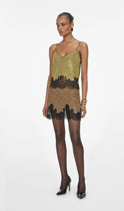 Elevate your evening wardrobe with the Champagne Crystal Set—a dazzling combination of a relaxed-fit chainmail top and a flirtatious mini skirt. The top features champagne crystals, lace-trimmed hem, button-back closure, and full lining for comfort and polish. The matching fitted mini skirt, detailed with delicate lace trim and a back zipper, offers subtle allure with its minimal stretch and unlined finish. 