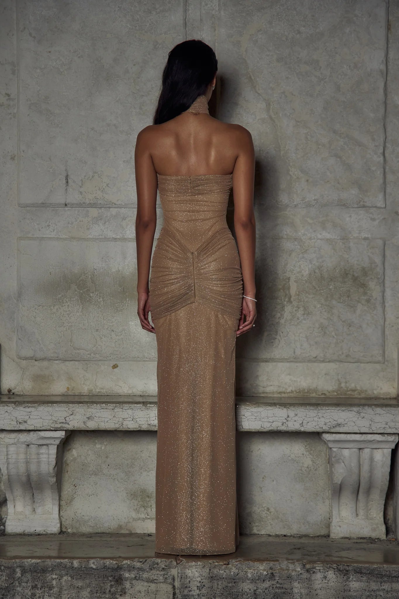 Indulge in luxury with The Starlite Dress in Diamond Sand. This strapless stretch gown boasts a chic collar, silicone gripper for a secure neckline, and an invisible zipper with hook and eye closure. The removable power mesh lining provides the perfect fit for your special event.