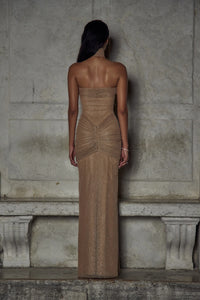Indulge in luxury with The Starlite Dress in Diamond Sand. This strapless stretch gown boasts a chic collar, silicone gripper for a secure neckline, and an invisible zipper with hook and eye closure. The removable power mesh lining provides the perfect fit for your special event.