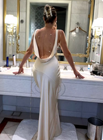 Load image into Gallery viewer, Introducing the Anja Satin Dress - a sleek and elegant sleeveless gown with a pleated V-neck and smooth, open back. The flowing silhouette and refined details make this dress perfect for any upscale event. Elevate your style with the Anja dress.
